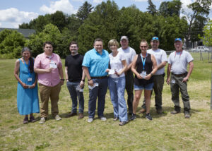 A group poses for a photo with their ICARE Awards.