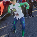 A chil wearing a Hulk costume runs.