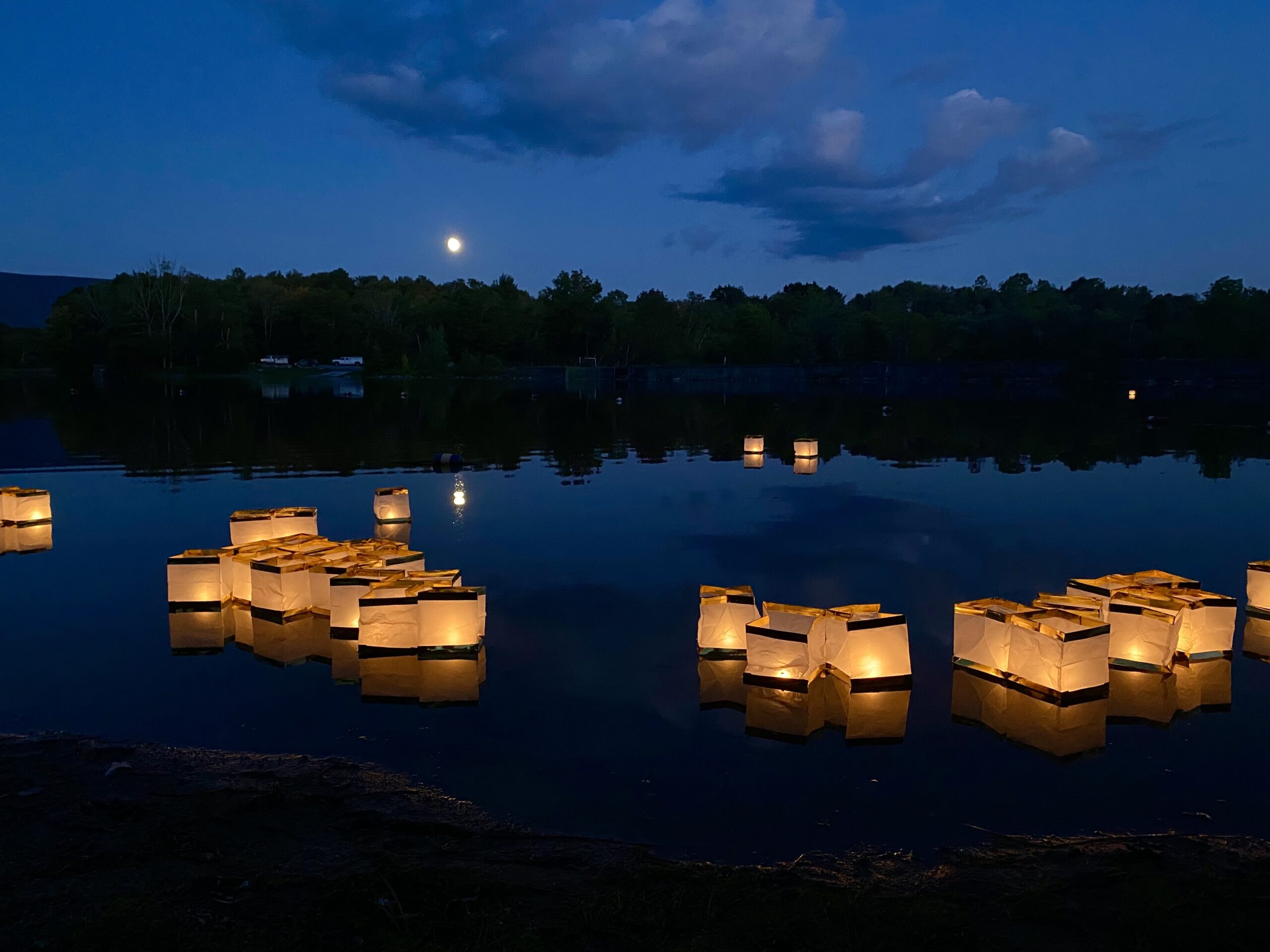 Lighted lanterns floating on lake