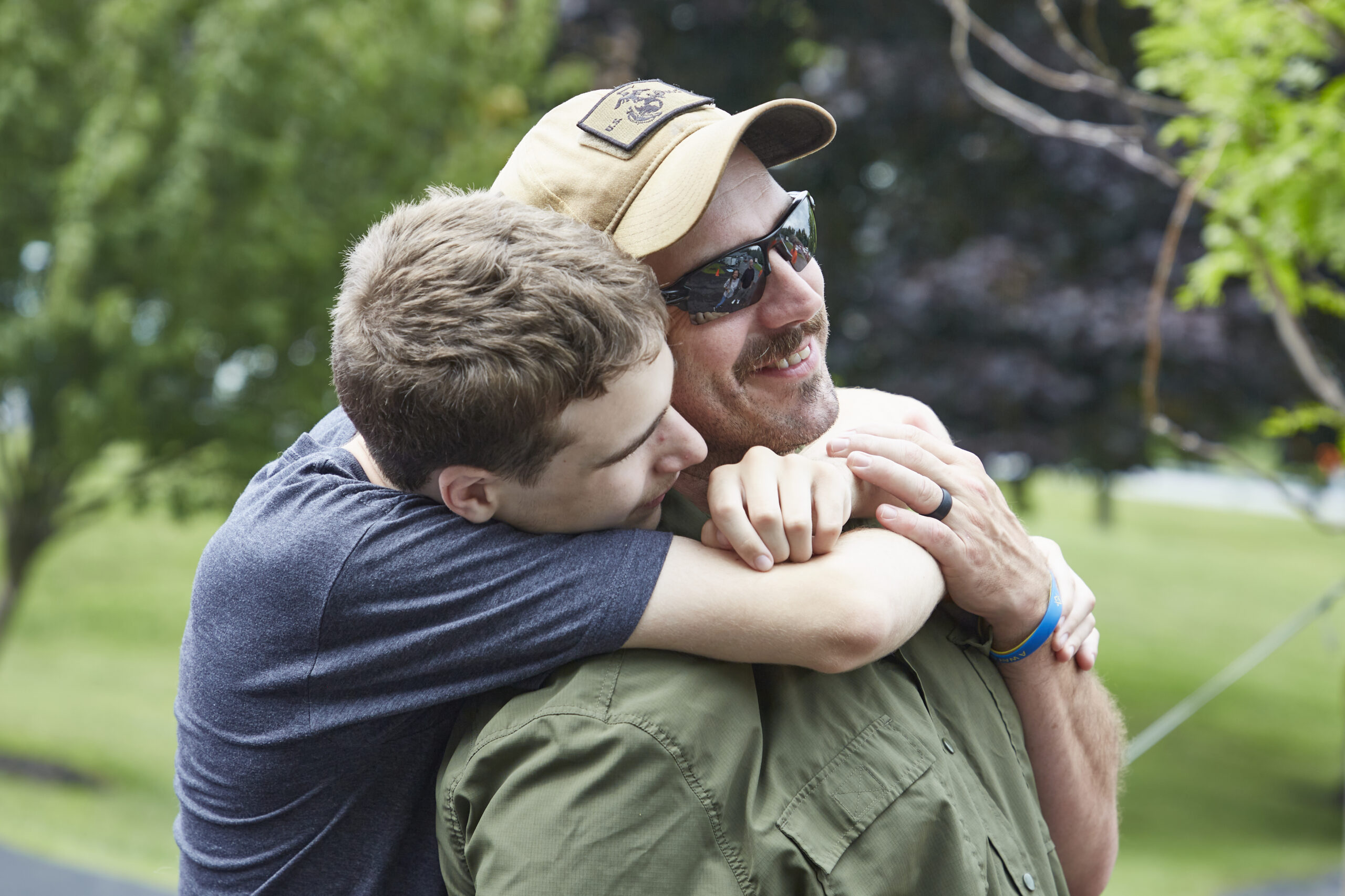 Young man embracing another man in a hug