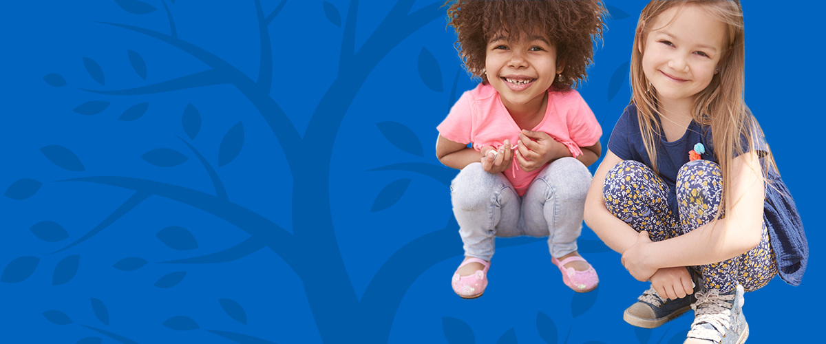 two children sitting next to each other and smiling on a blue background