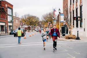 kids run in a race in a downtown setting