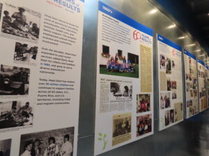 A long row of large informational posters lines a corridor