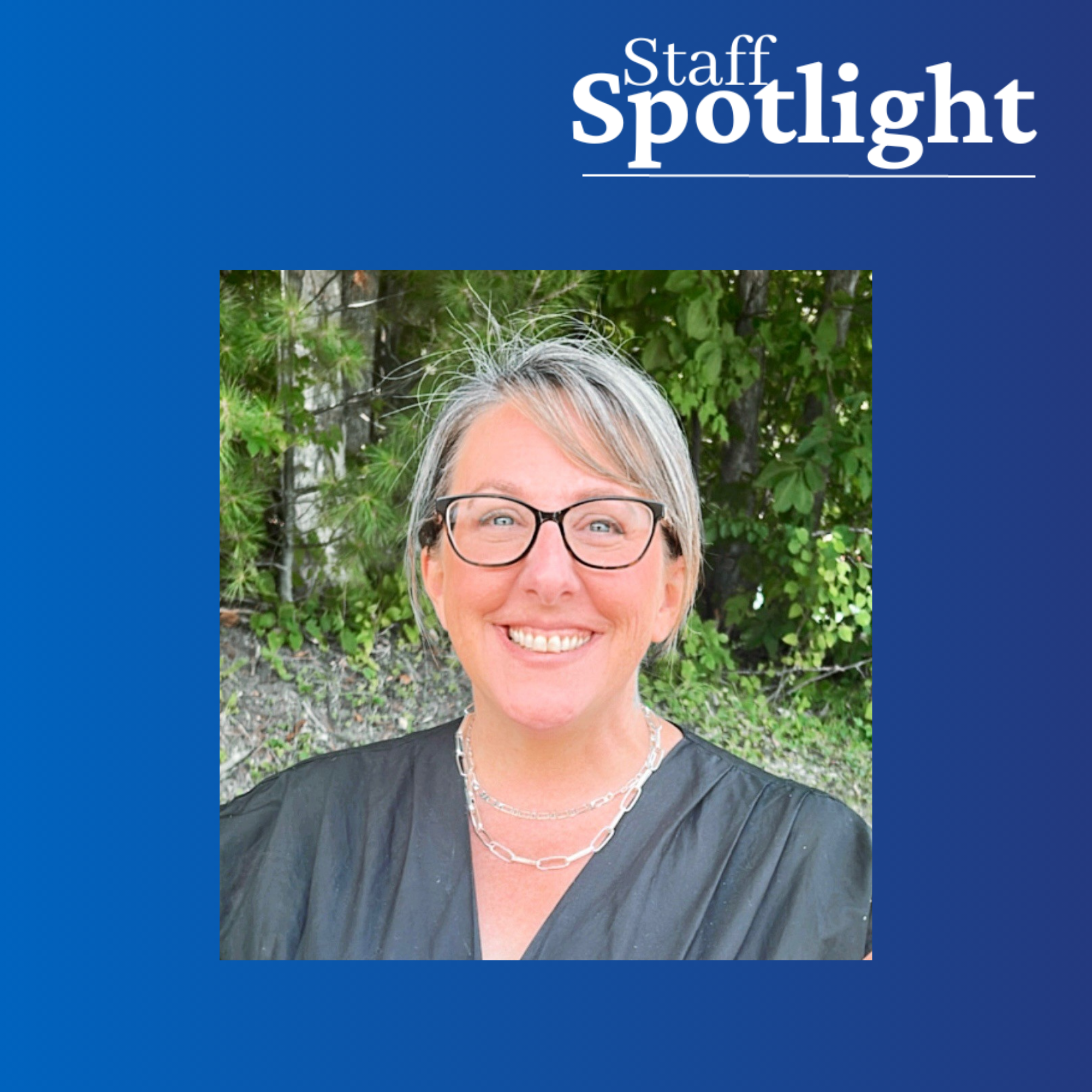 smiling woman with blonde hair and glasses against a green natural background, against a dark blue gradient border with Staff Spotlight in the top right